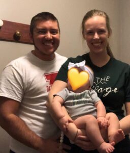 Sydney and Jenna Dressler hold one of their foster children.